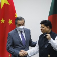 Chinese Foreign Minister Wang Yi, left, stands with his Bangladeshi counterpart A.K. Abdul Momen during their meeting in Dhaka,