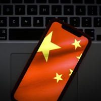 The Chinese flag is seen on a portable mobile device in this photo illustration