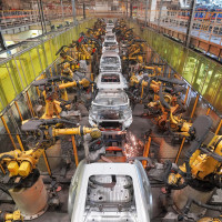 Robots work on a vehicle assembly line in east China's Shandong province