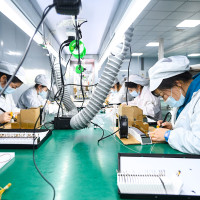 Workers make liquid crystal displays and modules on the production line at a semiconductor production workshop in China