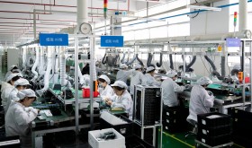 Workers work on a production line to produce electrical products for domestic and Southeast Asian markets in Nantong